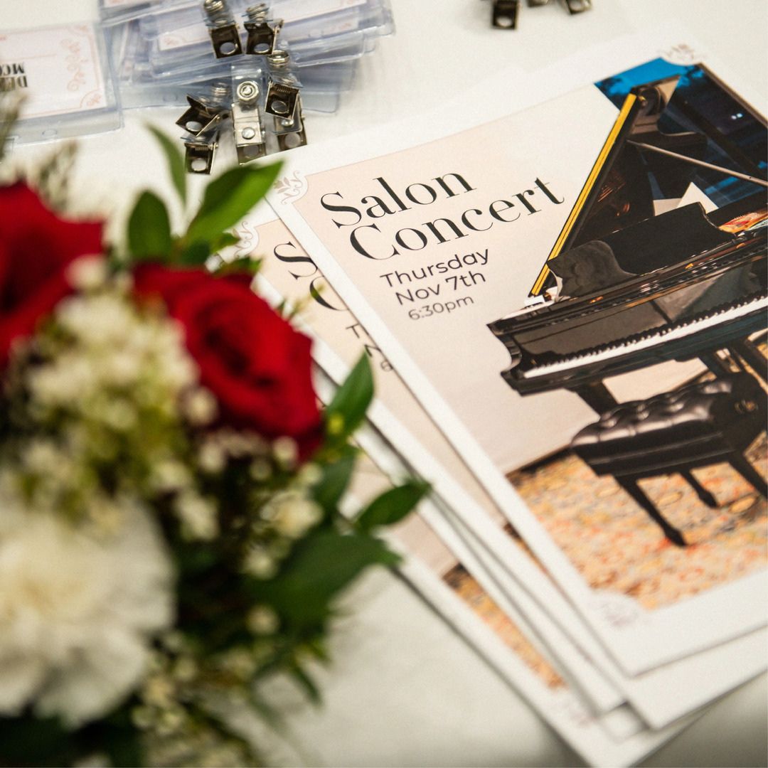 Detail shot of the printed event program resting beside a beautiful floral arrangement.