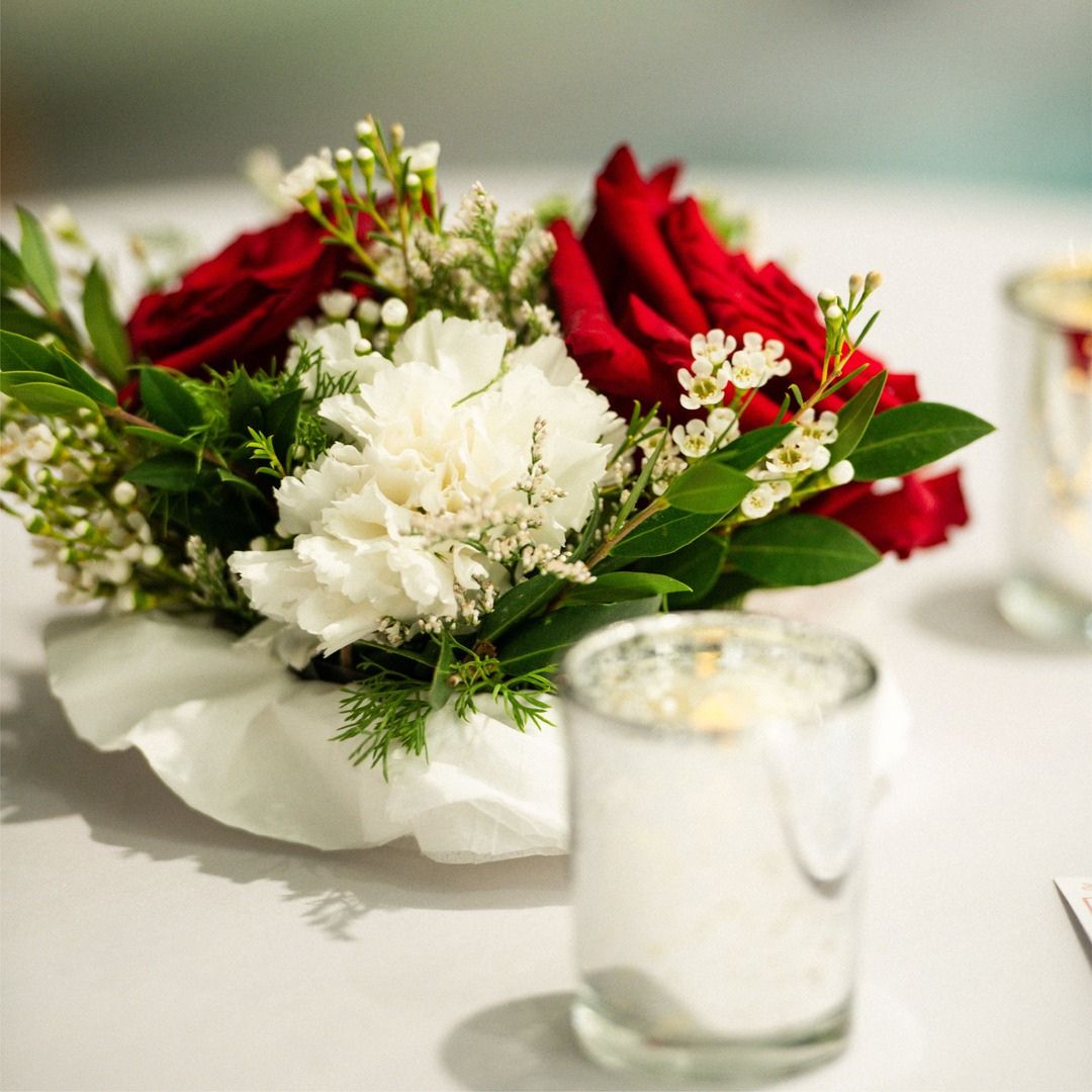 Elegant white and red floral centerpiece adding a touch of nature to th