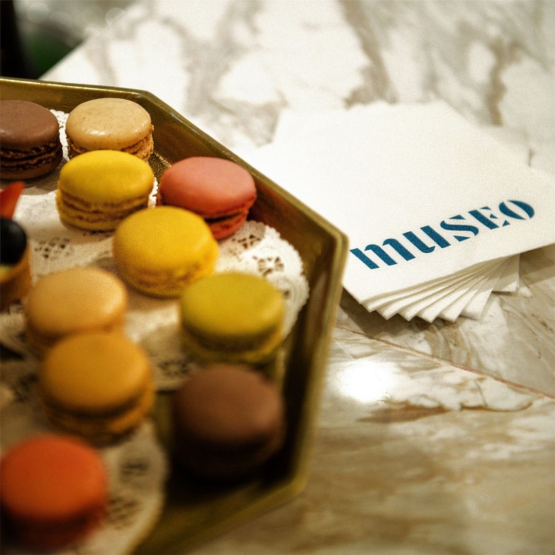 A curated box of colorful gourmet macarons prepared for event guests.