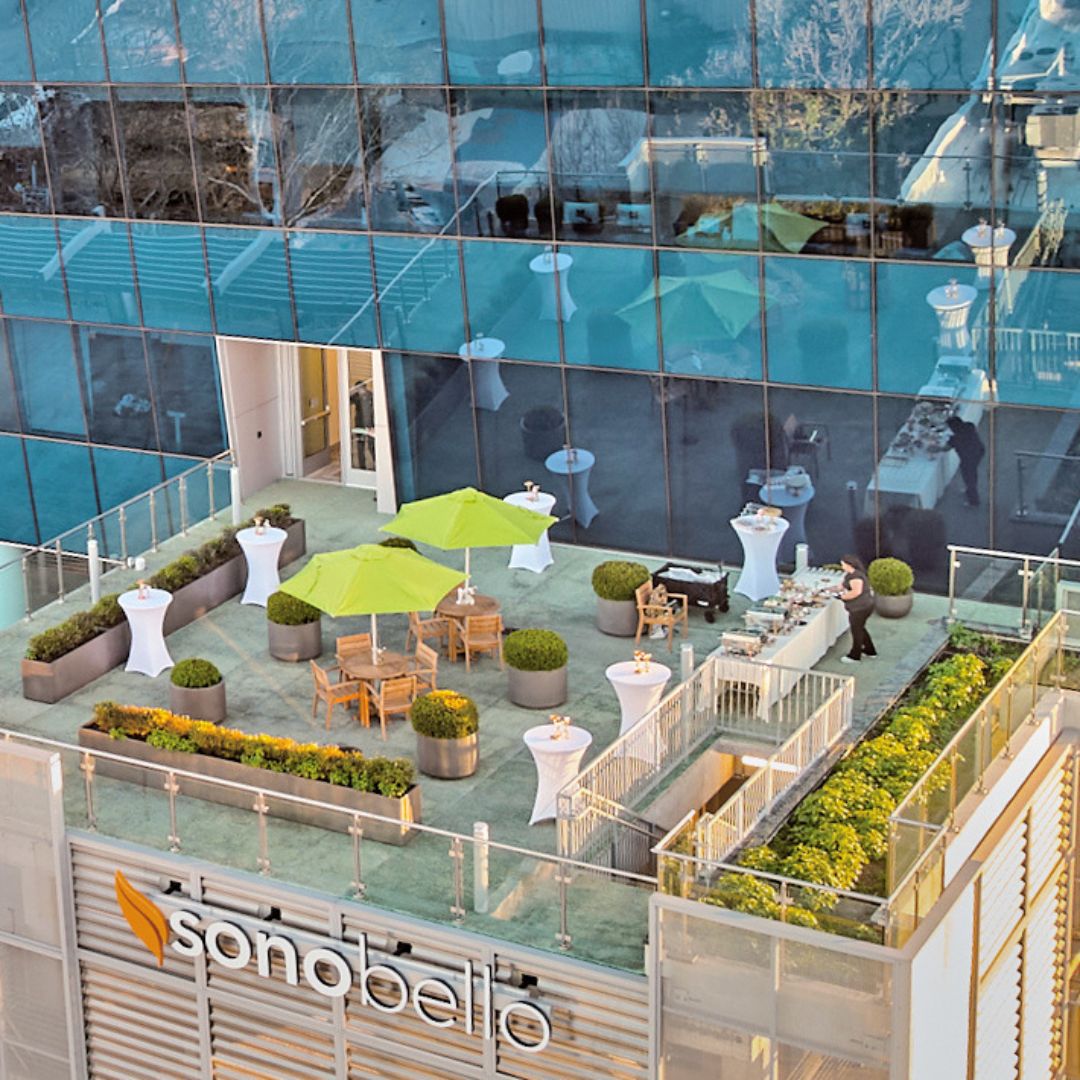 High-angle view of the Museo Houston terrace, showing the modern furniture and architectural design of the outdoor space.