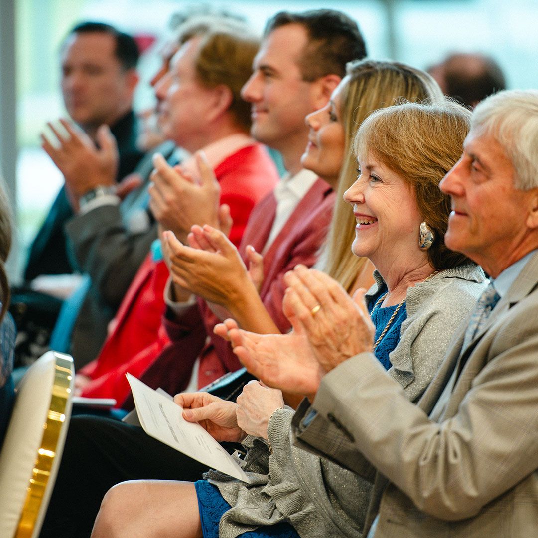 Guests applauding during a ceremony or cultural performance at Museo Houston.