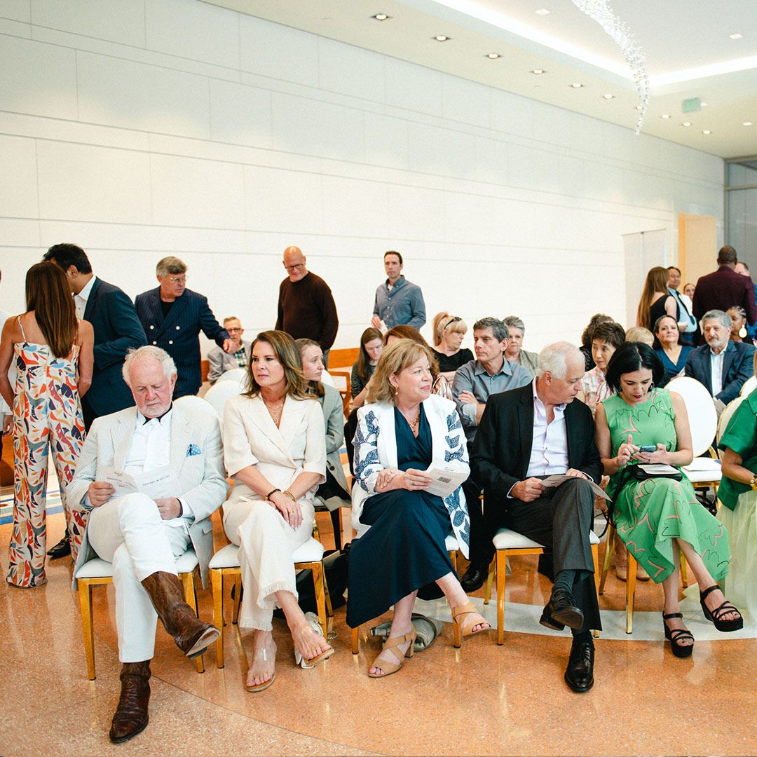 Guests in formal attire seated during a high-profile cultural partnership event at Museo.