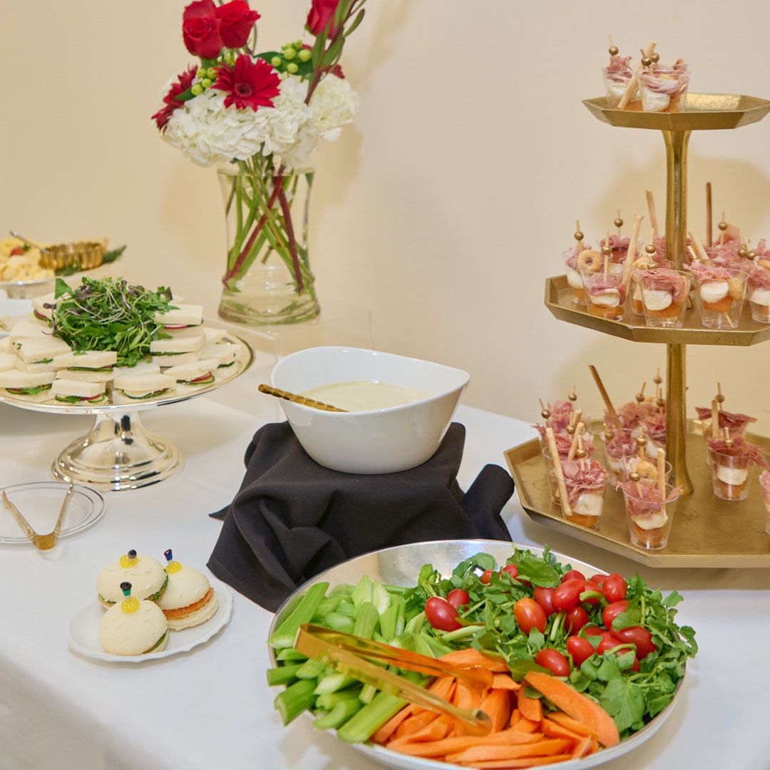 A sophisticated catering display featuring fresh vegetables and artisan appetizers for a Museo Houston event.