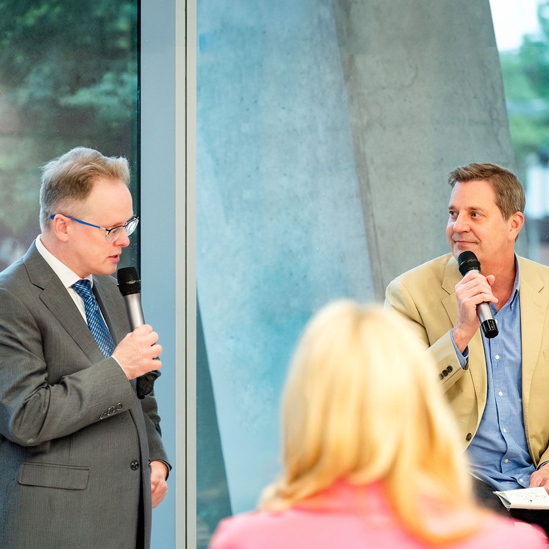 A guest speaker engaging with the audience during a medical community milestone event.