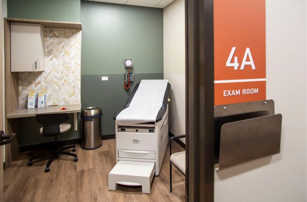 State-of-the-art medical examination room at Museo Institute featuring premium equipment and wood finishes.