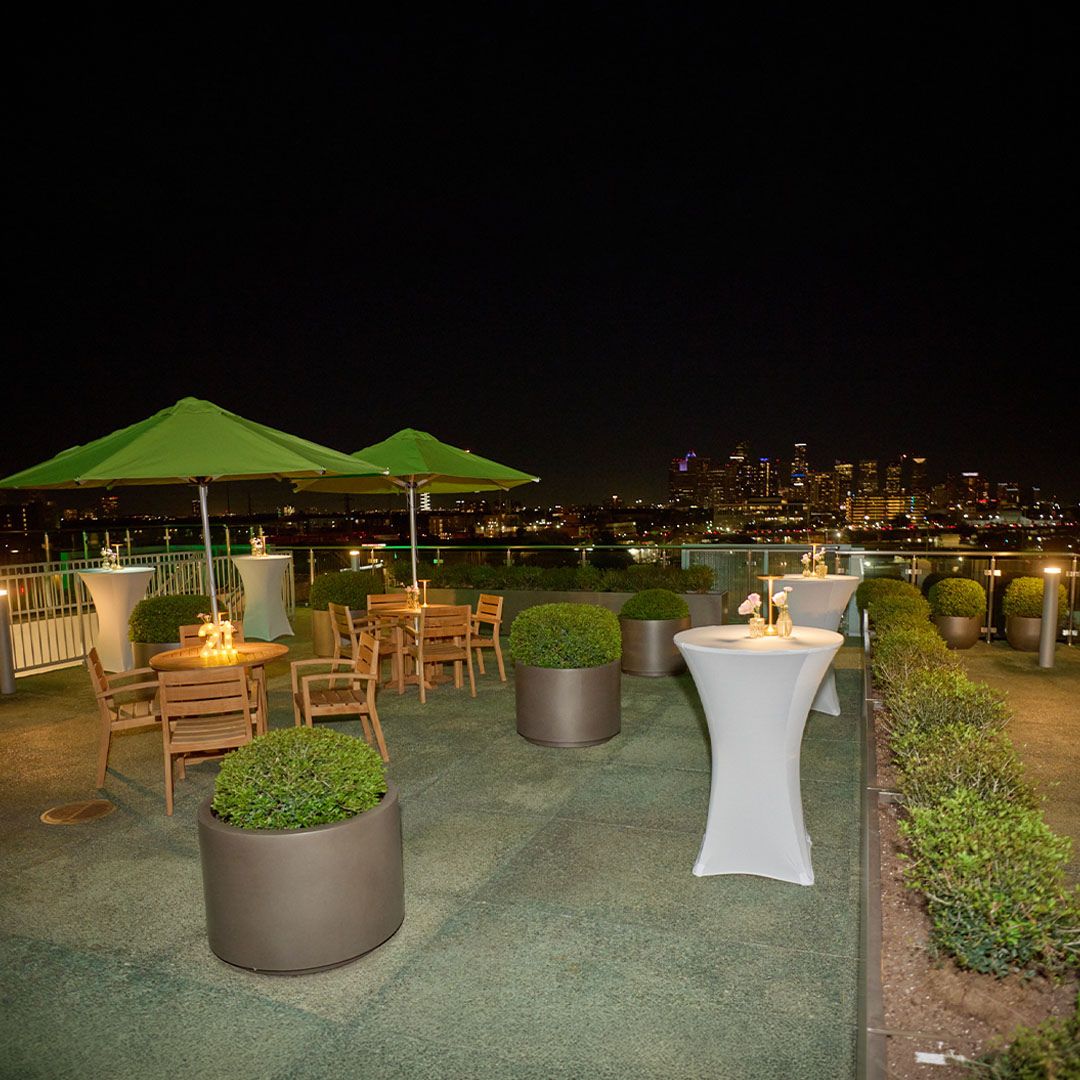 Elegant evening ambiance on the Museo rooftop featuring glowing cocktail tables and city lights.