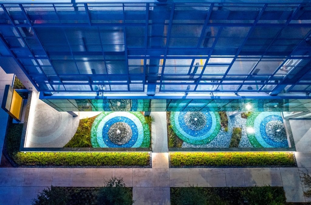 Outdoor tiered dark stone water fountain surrounded by beautiful landscaping at Museo Institute.
