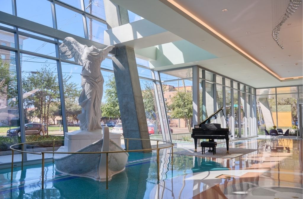 Spacious luxury event space and lobby at Museo Houston with elegant patterned floors and floor-to-ceiling windows.