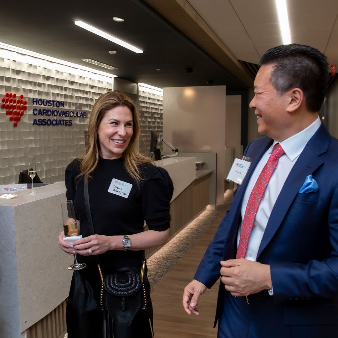 Two guests sharing a lighthearted moment during a professional networking event at the Museo Institute for Medical Arts.