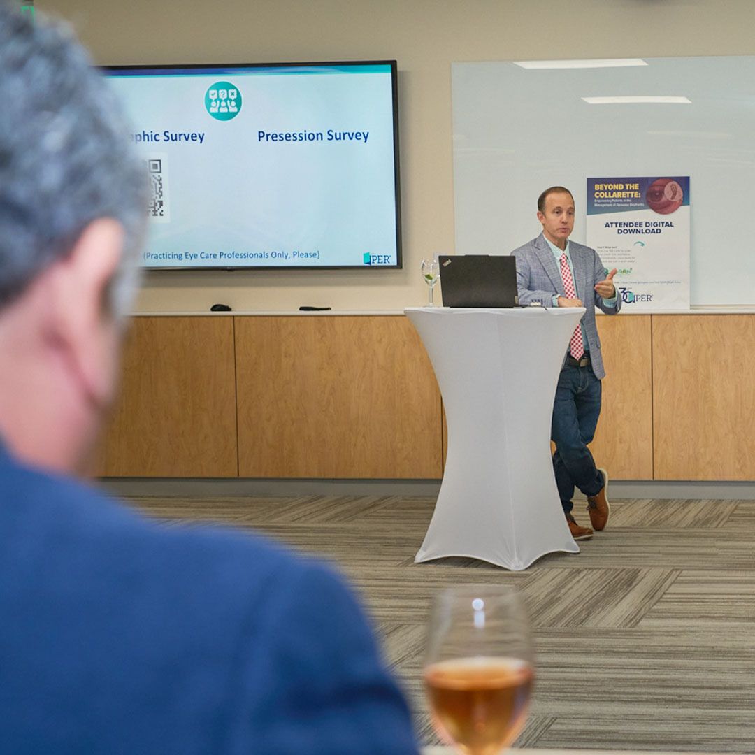A view from the audience of a medical professional presenting research on a digital screen at Museo Houston.
