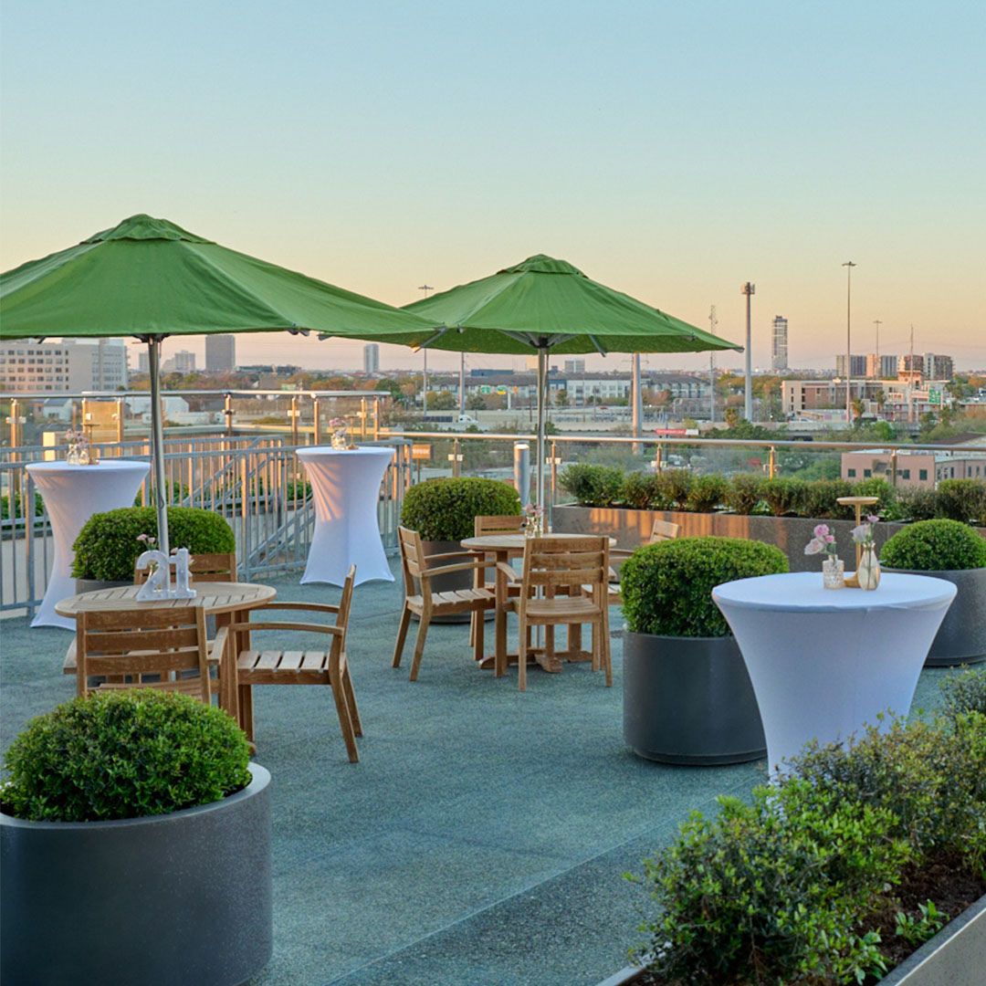 Guests enjoying the comfortable outdoor seating and city views at Museo Houston during a sunset reception.