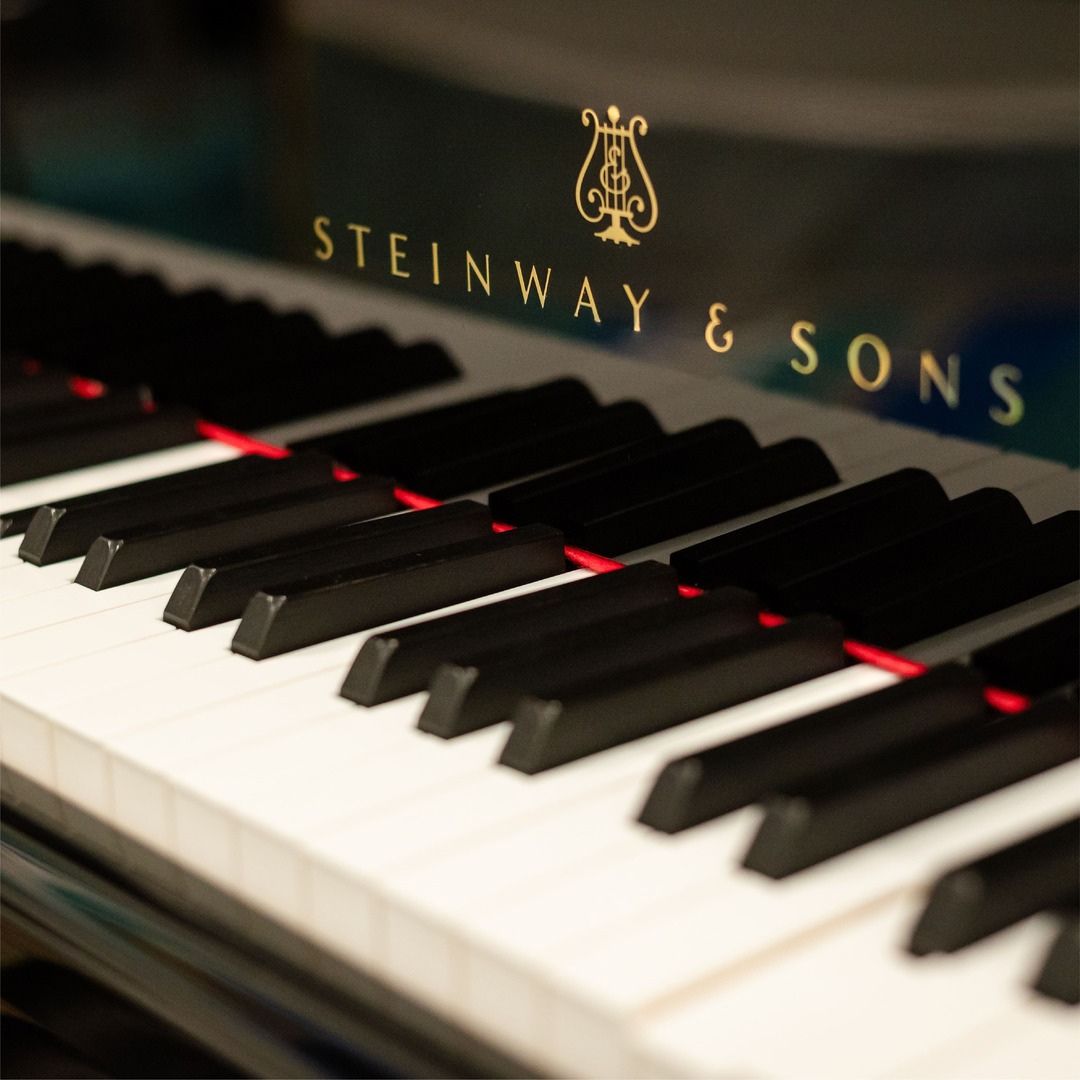 Close-up of Steinway & Sons piano keys, highlighting the elegant musical ambiance at Museo Houston.